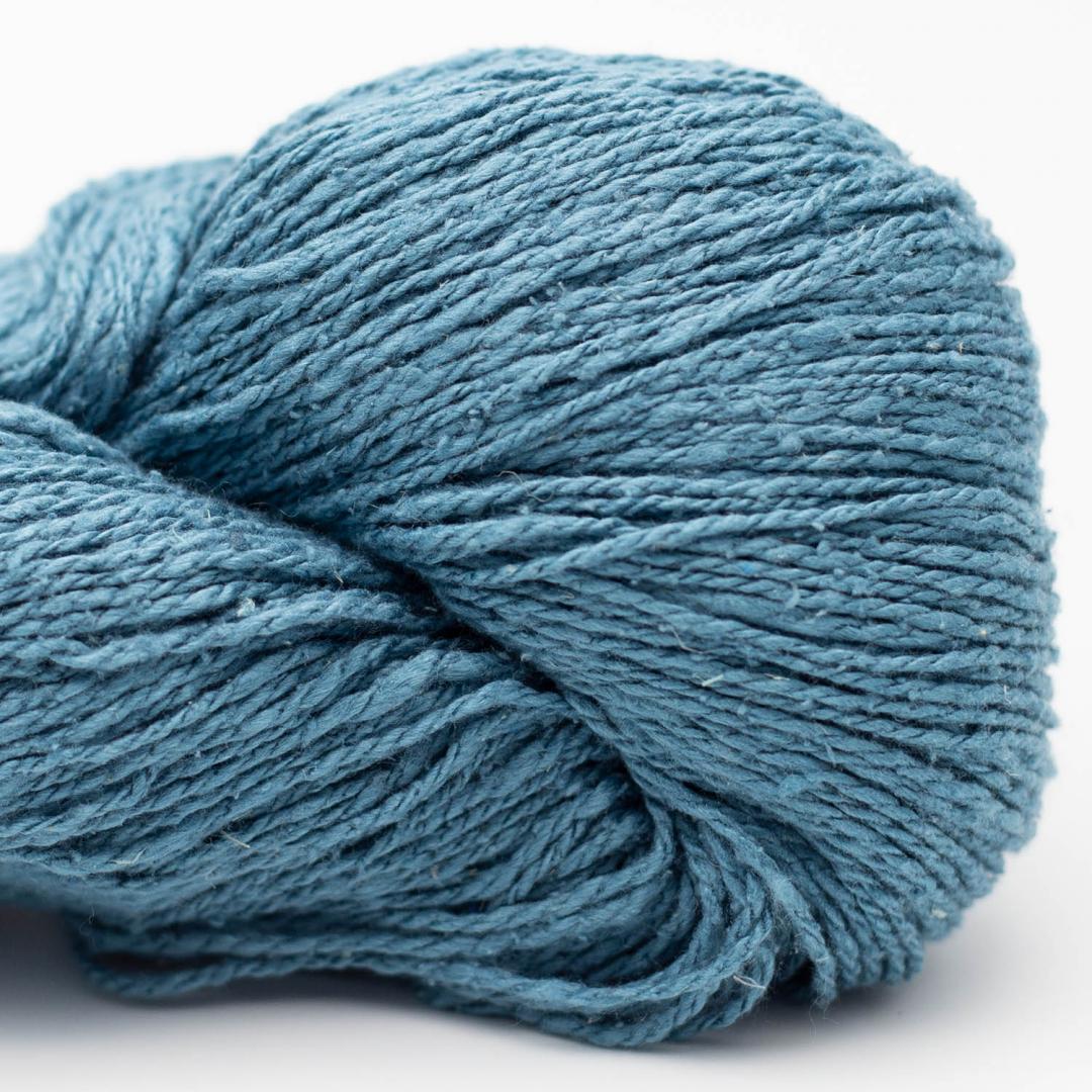 Blue skein of yarn on a white background