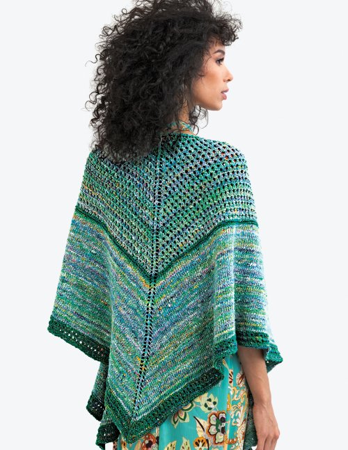 Woman wearing a colorful knitted shawl on a white background