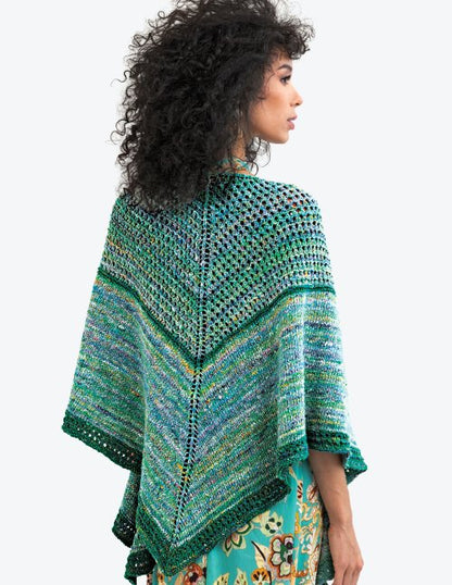 Woman wearing a colorful knitted shawl on a white background