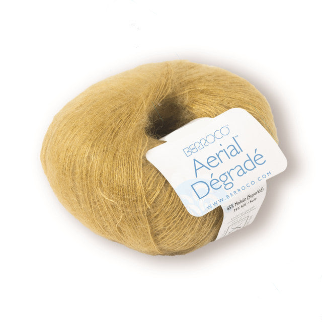 Ball of gold yarn with a label on a white background