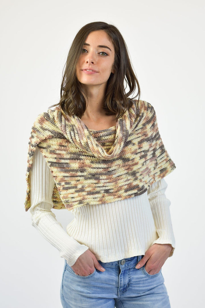 Woman wearing a patterned scarf on a white background