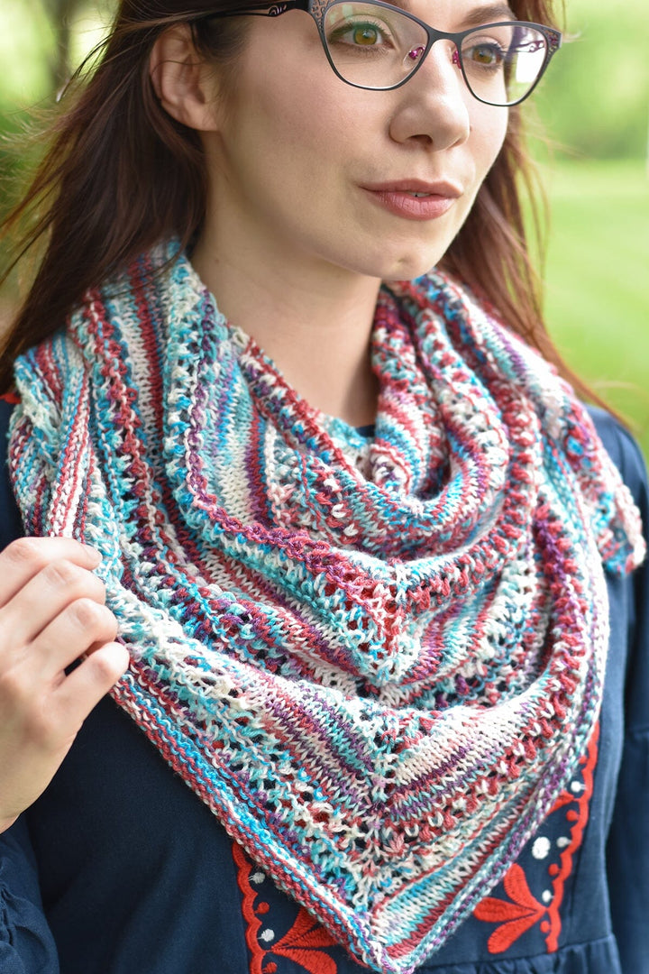Woman wearing a colorful knitted scarf outdoors